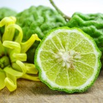 Bergamot fresh fruit on wooden background with yellow flower : natural herb food, spa, hair and body